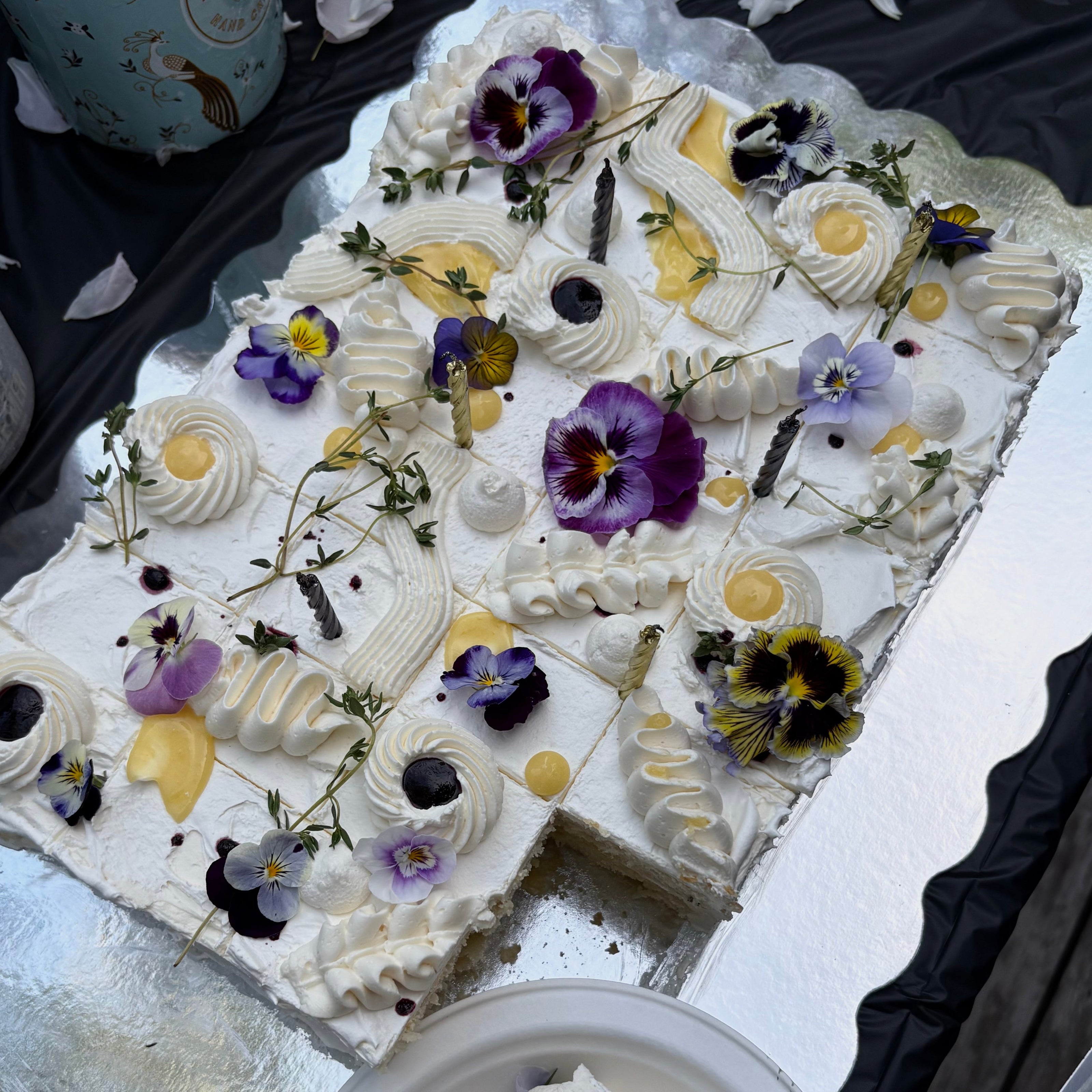 sheet cake with purple edible flowers